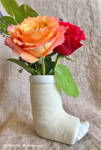 porcelain foot in a cast vase or mug with flowers, side view - break a leg